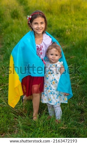 Child with Ukrainian flag patriot stop war. Selective focus. Kid.