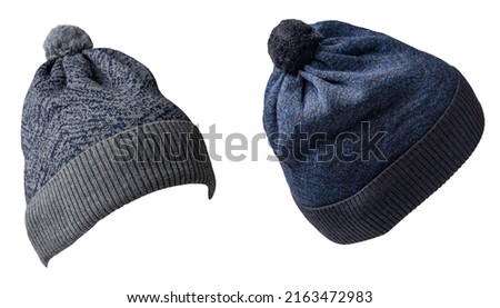 two knitted gray dark blue hats isolated on white background.hat with pompon .