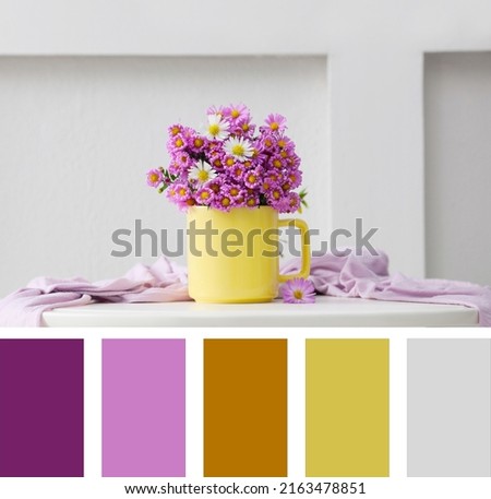 Cup with beautiful flowers and cloth on white table. Composition inspired by colors of the year 2021