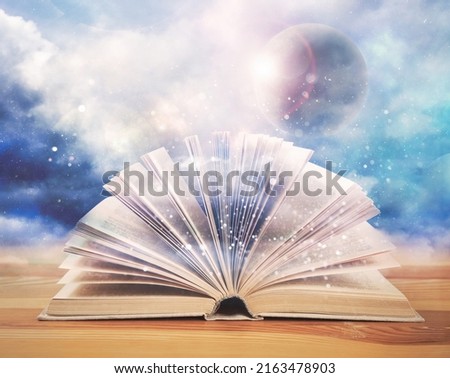 Open book with glitter overlay and beautiful sky on background