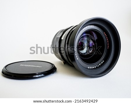 Steel photo lens on a white cyclorama