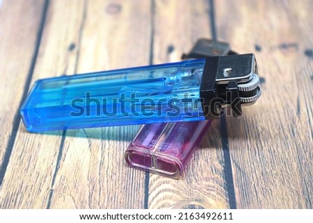 two gas lighters on the table Royalty-Free Stock Photo #2163492611