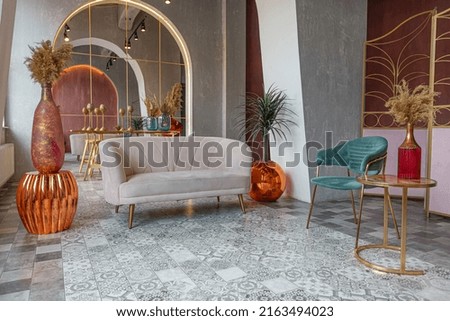 interior of a large apartment in oriental mixed with loft style with arches, led lighting and bright orange elements Royalty-Free Stock Photo #2163494023