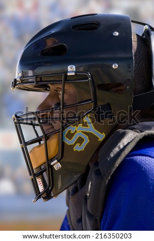 Close up of baseball catcher wearing helmet