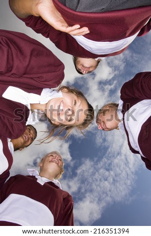 Smiling teenage girls in sports uniforms