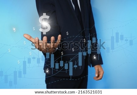Man demonstrating virtual dollar sign on light blue background, closeup