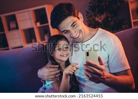 Photo of pretty funny father little school kid making order modern device late night indoors room home house
