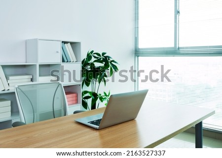 Modern workspace with computer and chair.