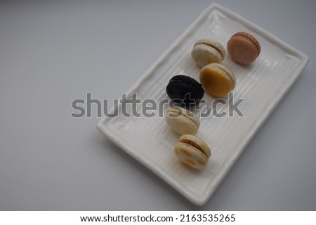 macaroons arranged standing on a rectangular plate