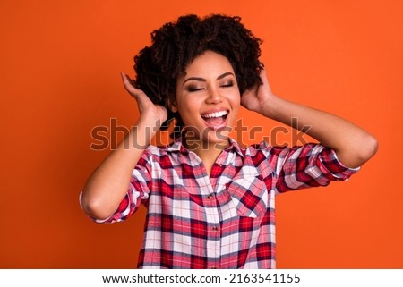 Photo of positive cheerful lady have new haircut enjoy her hair wear plaid outfit isolated vibrant color background