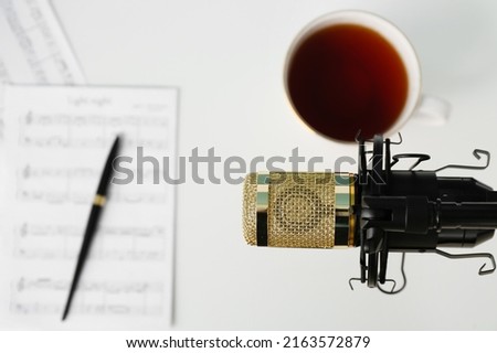 Professional microphone above composer's workplace, closeup
