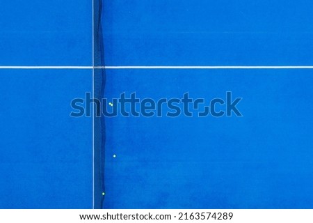 aerial view of a paddle tennis court with four balls near the net Royalty-Free Stock Photo #2163574289