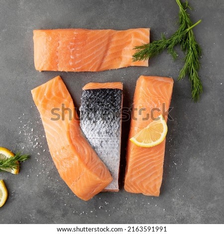 Delicious salmon pieces, appetizing red fish pieces, salted salmon, atlantic salmon on a wooden board