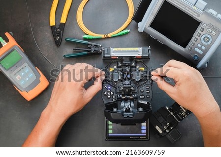 Fusion Splicing Tool, a set of fiber-optic or fiber-optic splicers for high-speed Internet connections. Royalty-Free Stock Photo #2163609759
