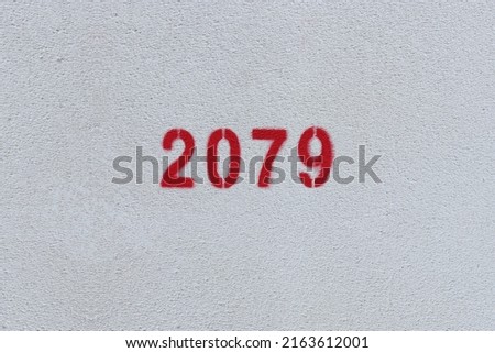Red Number 2079 on the white wall. Spray paint.
