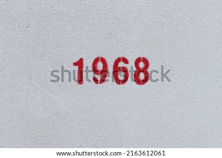 Red Number 1968 on the white wall. Spray paint.
