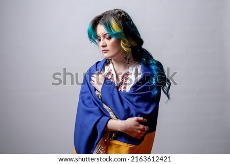 ukraine girl with blue and yellow hair in vyshyvanka on a white background. idea of ​​Ukrainian war. defense of the city, military girls. stop Russia
