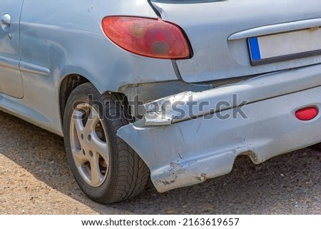Hanging Rear Bumper Off at Small Car Damage Accident Royalty-Free Stock Photo #2163619657