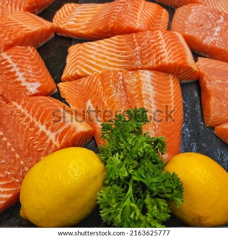 Fresh salmon, beautifully sliced  Put it on ice at the shelves of supermarkets around the world.  Some blur in the picture