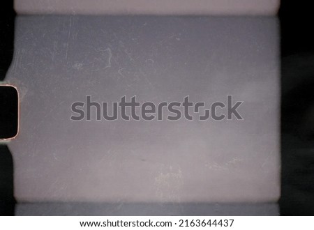scan of blank or empty 8mm film frame with dust and scratches, cool film border overlay. super 8 template. Royalty-Free Stock Photo #2163644437