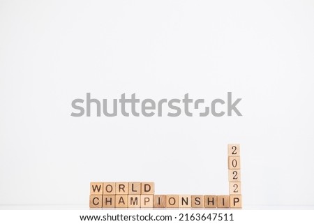 World championship 2022 word is written on wooden cubes on a white background.