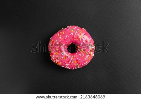 pink donut on black background