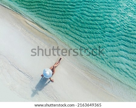 Holidays in the Maldives. Paradise tropical beach. Woman on the background of the sea and sunny beach. Travel, tourism and relaxation Royalty-Free Stock Photo #2163649365