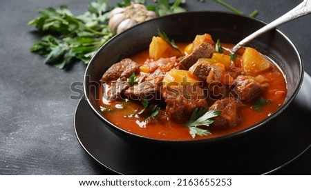 Beef goulash, soup and a stew, made of beef chuck steak, potatoes and plenty of paprika. Hungarian  traditional meal. Royalty-Free Stock Photo #2163655253