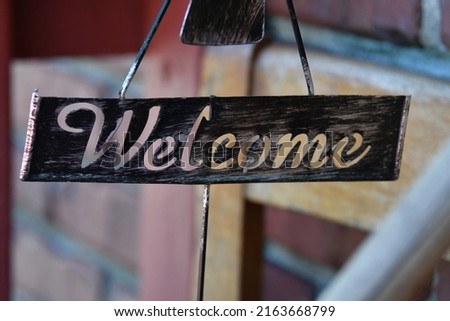Metal welcome sign by a building
