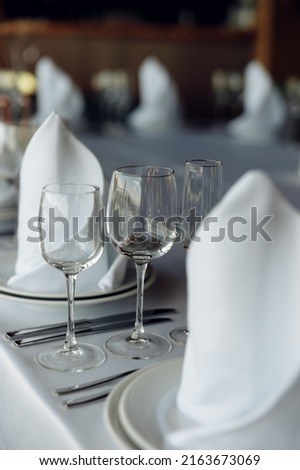 served table with glasses on a white tablecloth