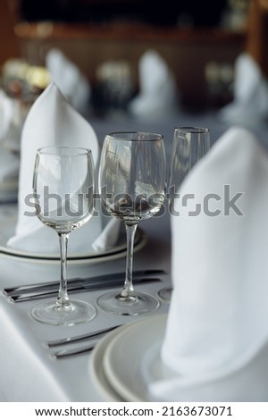 served table with glasses on a white tablecloth