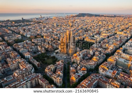 Aerial view of Barcelona Eixample residential district and Sagrada Familia Basilica at sunrise. Catalonia, Spain. Cityscape with typical urban octagon blocks Royalty-Free Stock Photo #2163690845