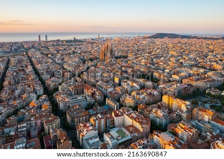 Aerial view of Barcelona Eixample residential district and Sagrada Familia Basilica at sunrise. Catalonia, Spain. Cityscape with typical urban octagon blocks Royalty-Free Stock Photo #2163690847