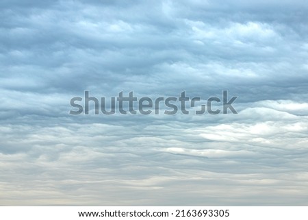 Heavenly pattern. Gentle colors of the cloudy sky. Cold and warm. Picture of beautiful nature. Calm mood. Changeable weather. Interior art.