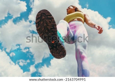 Full body training. Portrait of young muscular girl jumping