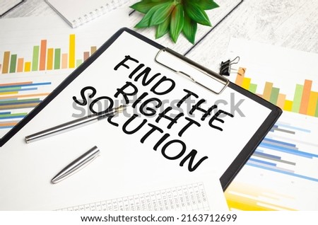 stickers, plant, pen and a white notebook with the text Find The Right Solution