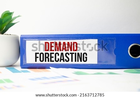 notepad with the inscription - Demand Forecasting on blue file folder
