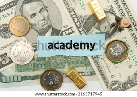 academy.The word is written on a slip of paper,on colored background. professional terms of finance, business words, economic phrases. concept of economy.