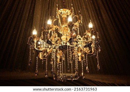 luxury Chandelier Luxury gold chandelier on wooden wooden deroration. Classical lighting equipment. Interior decoration image Royalty-Free Stock Photo #2163731963