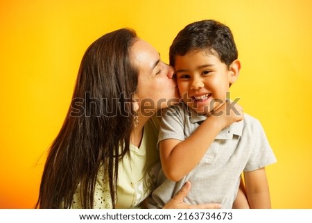 mom giving her son a kiss on the cheek