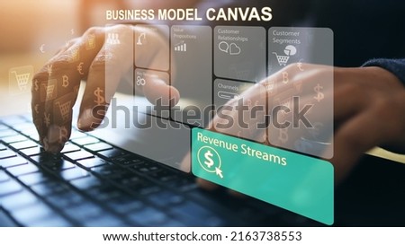 A businessman hand typing to working on a laptop computer notebook on the revenue stream section of the business model canvas or BMC. Money concept.