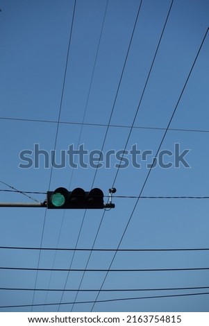 green traffic light with blue sky background