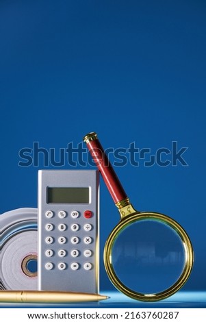  magnifying glass calculator and adding machine tape              