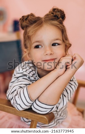 Portrait of a little beautiful girl with a stylish hairstyle in a beauty salon