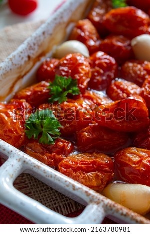Small tomatoes-cherry, baked tomatoes with olive oil, garlic and seasonings