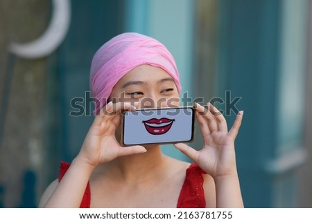 ASIAN GIRL WITH A SMILE ON THE MOBILE