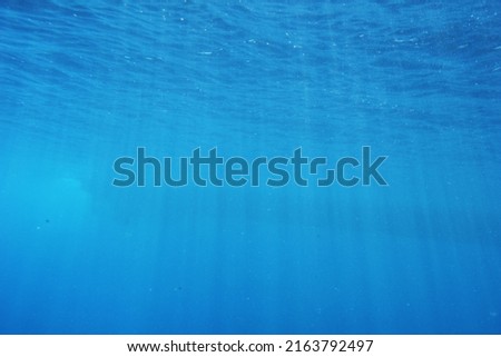 Light rays filtering underwater, enhanced photo.