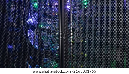 Image of close up of purple and green lights in computer server. global technology, data processing and connections concept.