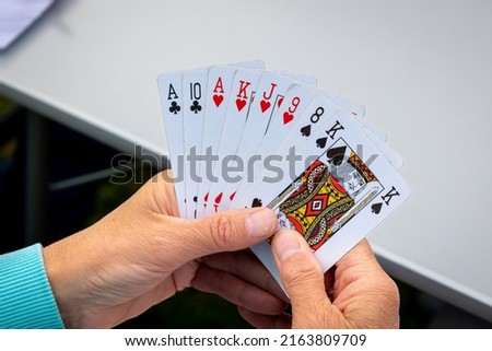 A handful of playing cards, to play the favorite game of belote, with four people, photo taken in the Netherlands Royalty-Free Stock Photo #2163809709