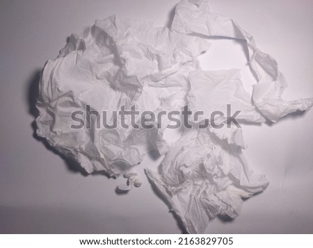 a bunch of crumpled tissues arranged on a white background